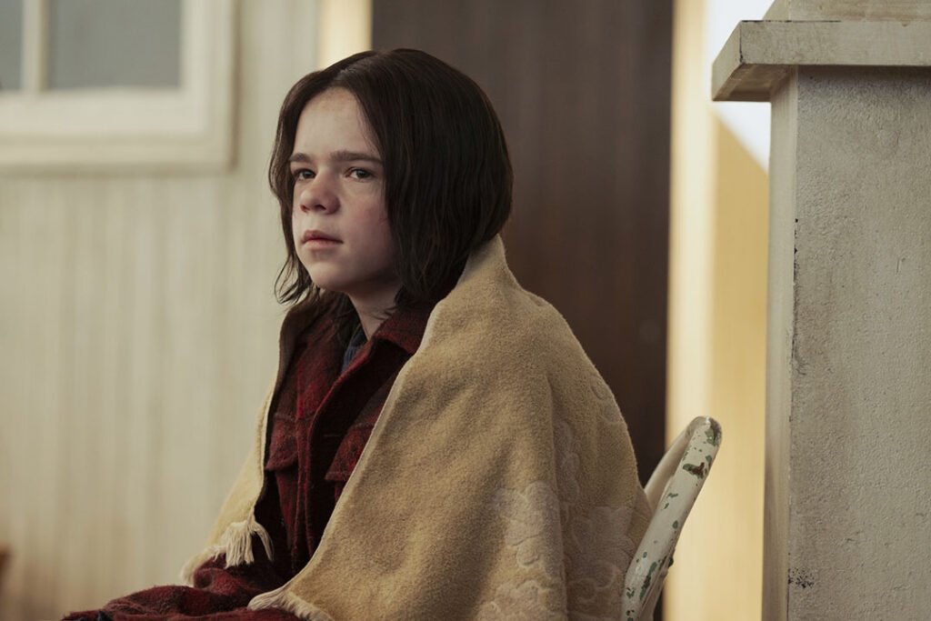 Matty is sitting in a chair, a blanket on his shoulder.